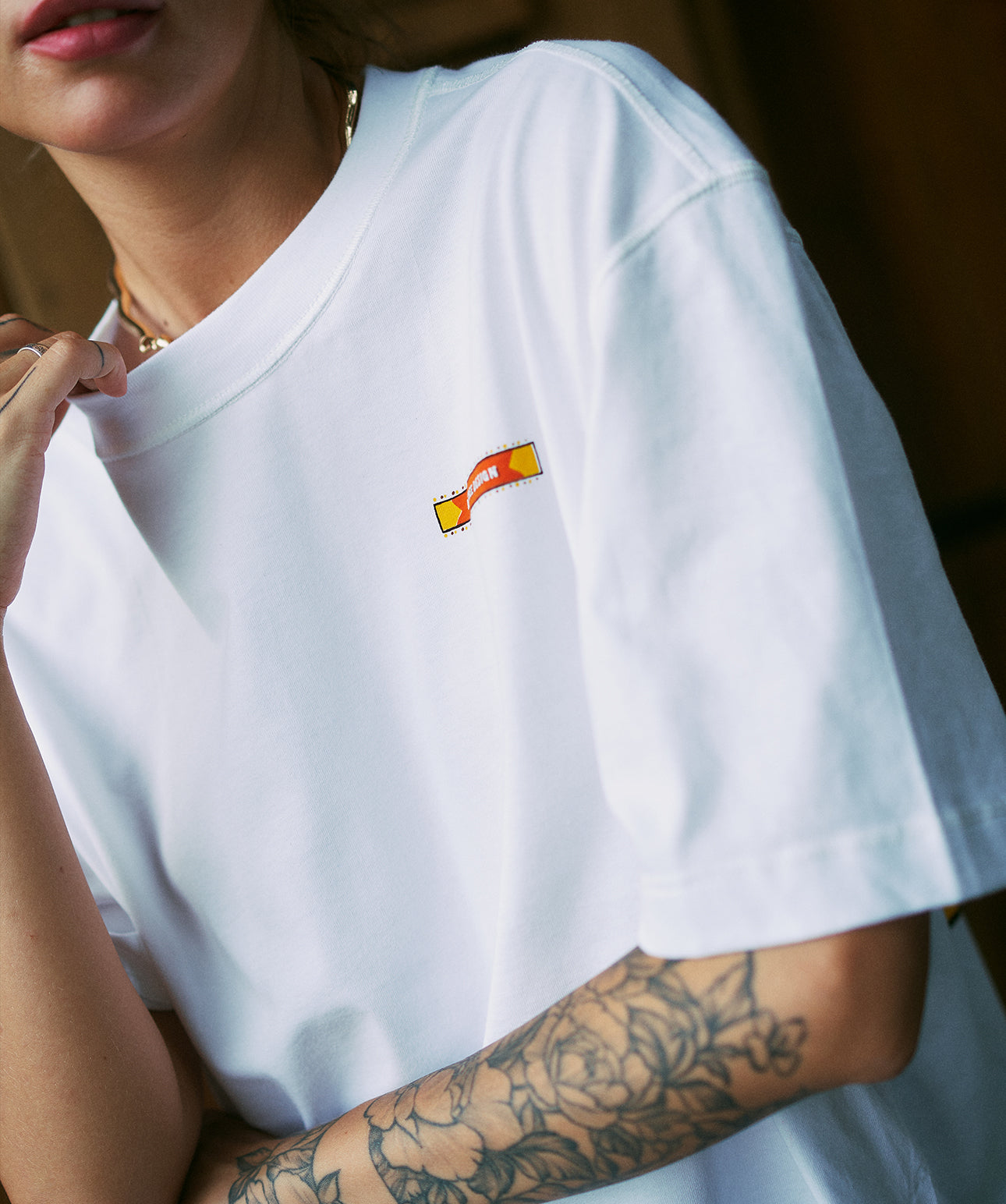 front logo Woman wearing white oversized cropped unisex t-shirt by Artree Design with minimal

