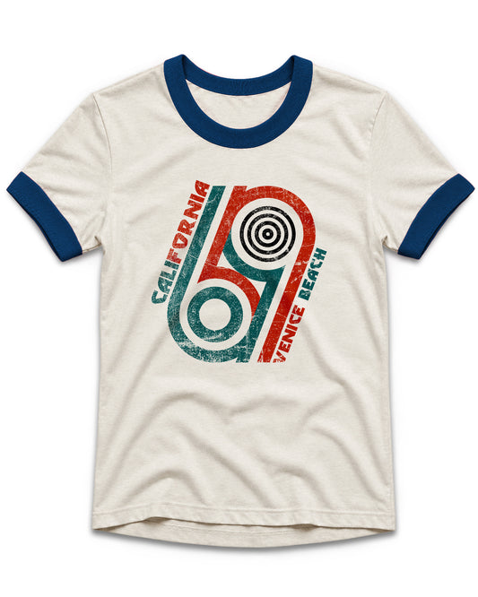 An off-white ringer t-shirt with navy blue collar and sleeve cuffs, featuring a retro-style graphic of a cassette tape in red and teal with the words 'CALIFORNIA' and 'VENICE BEACH'.