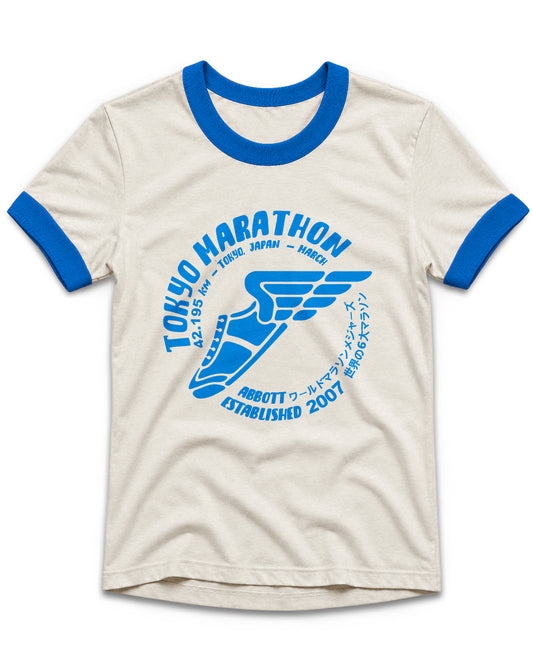 An off-white ringer t-shirt with blue collar and sleeve cuffs, featuring a blue graphic print of a marathon shoe and the text 'TOKYO MARATHON' and 'ABBOTT COLD-MARATHON ESTABLISHED 2007'.